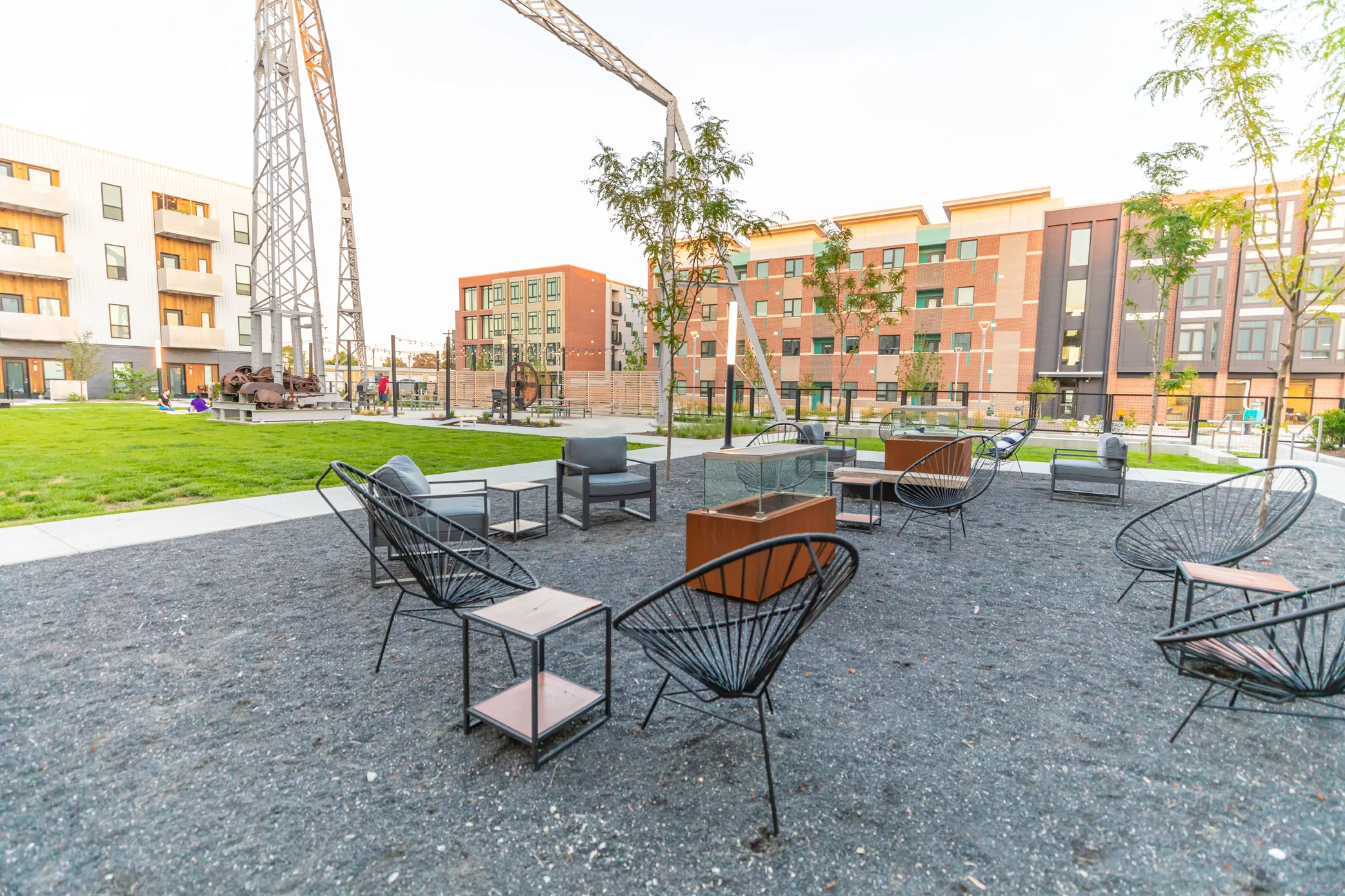 Rowat courtyard firepit seating and historic derrick in daylight