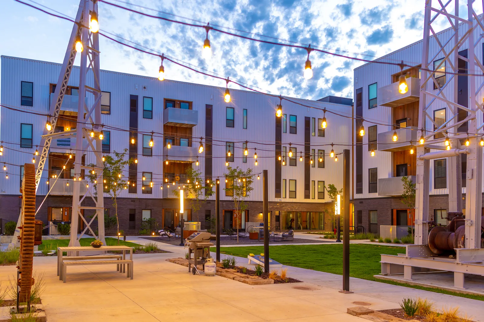 The historic stone derrick in Rowat’s courtyard under string lights